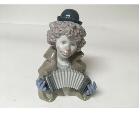 A Lladro figure of a clown playing an instrument 