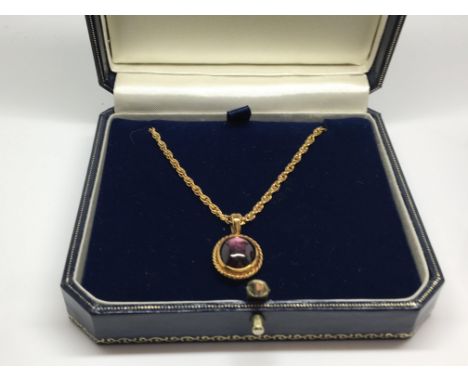 A  fine Indian star ruby, set in a 18 ct gold pendant with conforming chain together a matching pair of earrings 