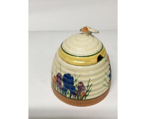 A Clarice cliff preserve pot decated in the crocus pattern 