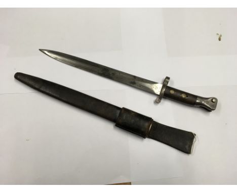 A British Pattern 1888 Mk.1 bayonet with a leather scabbard.