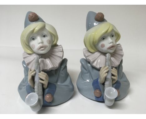 Two Lladro figures of a clown playing with an instrument 