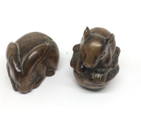 Two well detailed Japanese wooden netsuke, modelled as a mouse and rabbit, both signed