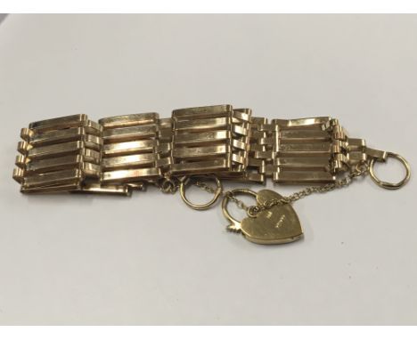 A 9ct Gold gate bracelet with a padlock clasp weight 10g approximately 10g approximately. 