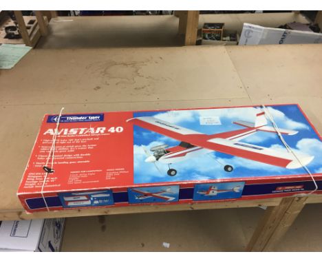 A boxed Avistar 40 wooden radio controlled aircraft by Thunder Tiger , the model is unmade but has a new engine inside the bo