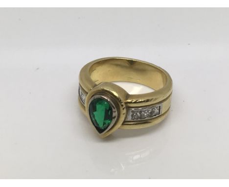 A six diamond ring inset with a central teardrop shaped green stone, approx size K and 10g.