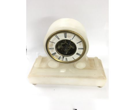 A small alabaster sketleton mechansism mantle clock 23cm in height - 1 foot loose
