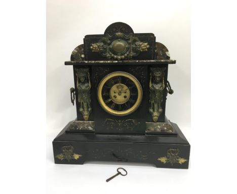An eight day slate and marble mantle clock with chime and open escapement, key included.
