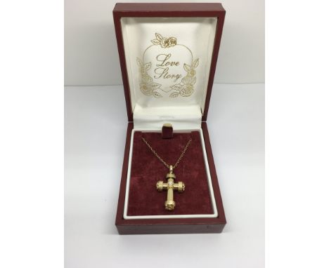 An 18ct yellow gold and diamond set ornate cross and chain