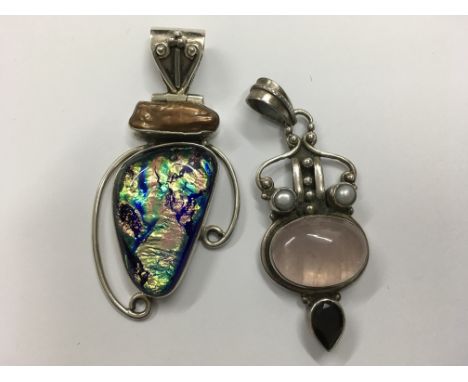 Two contemporary stone set silver pendants.