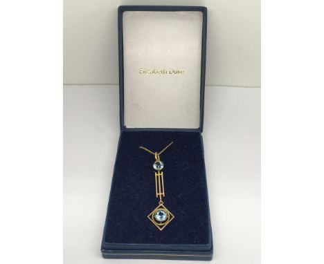 A 9ct gold Art Nouveau style pendant set with two topaz stones on chain