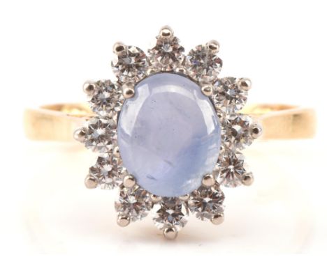 Star sapphire and diamond cluster ring, oval cabochon cut star sapphire weighing an estimated 4.26 carats, surrounded by twel