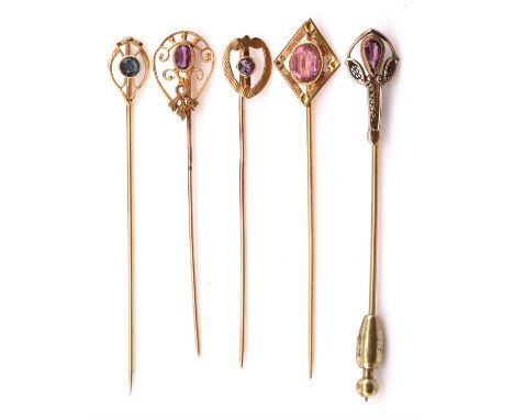 Five antique gem set stick pins, three pins set with an amethysts, one in a heart shaped setting stamped 14 ct, another ameth