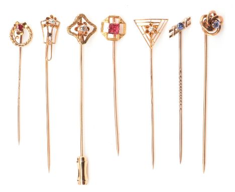 Seven antique gem set stick pins, including one set with a diamond in an open wire work setting stamped 14 ct, four 10 ct gem