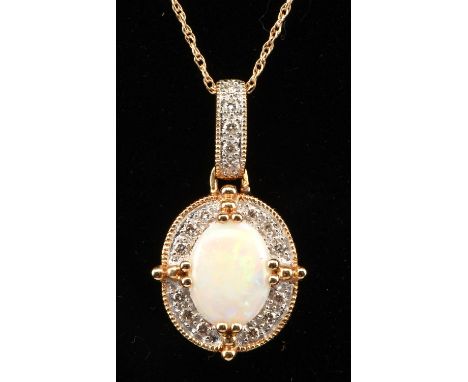 Opal and diamond halo pendant, opal measuring 7mm x 8mm surrounded by round brilliant cut diamonds, in a 14 ct yellow gold mo
