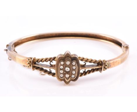 Late 19th C seed pearl and wire work bangle measuring 63mm in diameter, tested as silver gilt, in antique blue bangle case Co