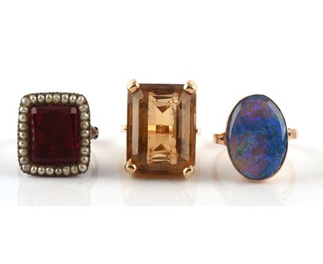 Three dress rings, including a single stone citrine ring, weighing an estimated 30.00 carats, size M1/2 in tested 14 ct, toge