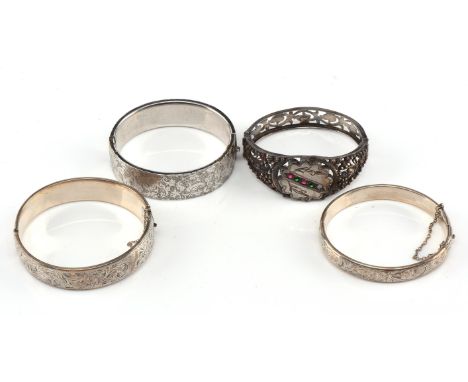 Four bangles, including one with cut steel and coloured paste detail, an engraved bangle hallmark Birmingham 1955, an engrave