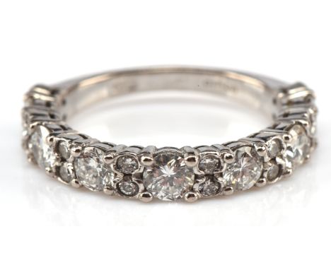 Diamond half eternity ring, with seven round brilliant cut diamonds and smaller diamonds interspersed, total estimated diamon