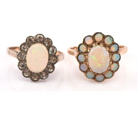 Two vintage opal cluster rings, including one with a central oval cabochon measuring 9mm x 7mm surrounded by 12 round opals, 