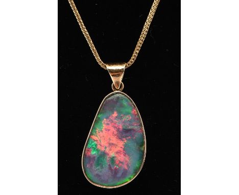 Opal pendant measuring 35x4x17mm in a 9 ct gold mount with closed back setting, 18 ct chain measuring 50cm long with a spring