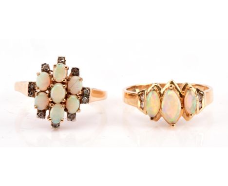 Two opal rings, including a three stone marquise cut cabochon opal and diamond ring stamped 14 ct, and a diamond and opal ova