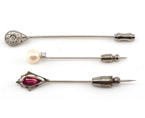 Three stick pins, one modern set with a round brilliant cut diamond, estimated weight  0.07 carats and a cream pearl 7mm in d