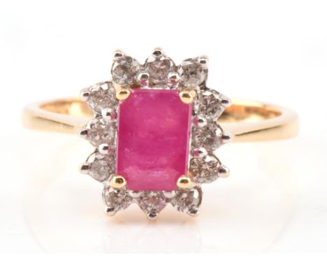 Ruby and diamond cluster ring, with a central step cut ruby certified 1.20 carat, mounted hallmarked Birmingham 2008, 18 ct y