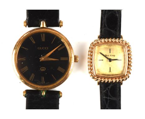 Two ladies wristwatches, including a Gucci watch, with a black dial and Roman numerals on a black leather strap, together wit