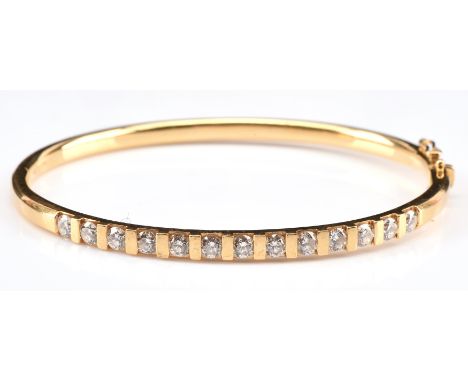 Diamond bangle set with 13 round brilliant cut diamonds with an estimated total weight of 1.50 carats, hallmarked 18 ct yello