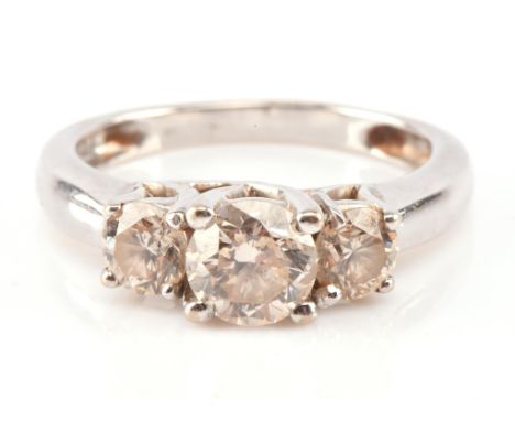 Diamond trilogy ring, with central diamond estimated as 0.72 carats, ring size K 1/2Condition Report:  gross weight 4.4grams 