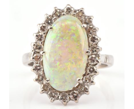 Opal and diamond dress ring, oval cabochon cut opal, estimated weight 4.10 carats, surrounded by twenty two round brilliant c