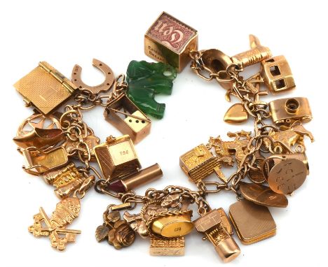 Vintage charm bracelet, with 33 charms attached including a charm of Big Ben, tennis racket book with paper pages, rocking ch