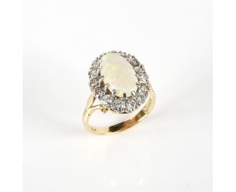Vintage opal and diamond ring, central oval cabochon cut opal, certified as 2.25 carats, surrounded by round brilliant cut di
