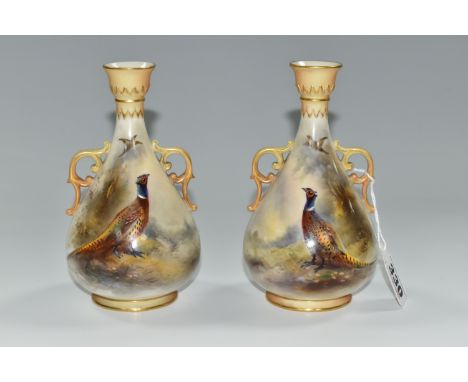 TWO ROYAL WORCESTER TWIN HANDLED BALUSTER VASES, HAND PAINTED WITH PHEASANTS BY JAMES STINTON, signed, blush ivory handles an