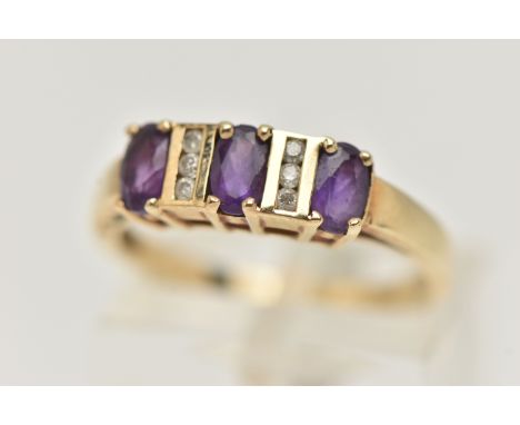 A 9CT GOLD AMETHYST AND DIAMOND HALF ETERNITY RING, set with three oval cut amethysts, each claw set and interspaced with six