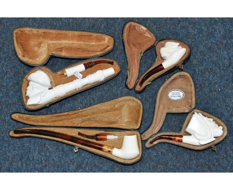 A BOX OF CASED REPRODUCTION MEERSCHAUM PIPES, comprising cased pipes in the forms of a mastiff type dog, a man smoking a pipe