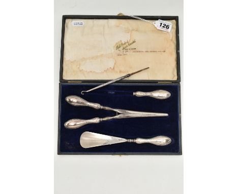 A CASED SILVER HANDLED SHOE HORN, BUTTON HOOK AND GLOVE STRETCHER SET, polished silver handles with beaded rims, hallmarked '