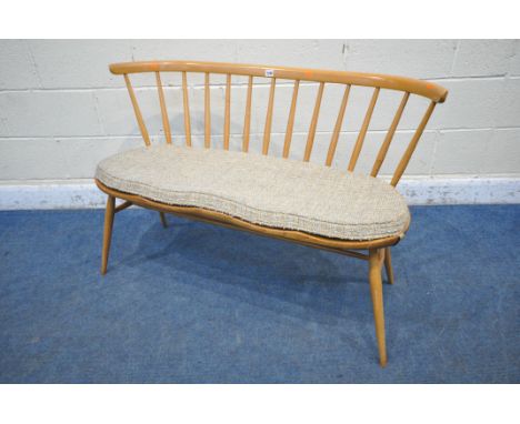 LUCIAN ERCOLANI, ERCOL, A MID CENTURY ELM AND BEECH DINING LOVE SEAT, with bentwood and spindle back rest, raised on cylindri