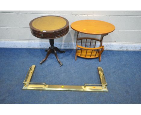 A 20TH CENTURY MAHOGANY DRUM TABLE, with tanned leather surface, turned support, on four legs, a magazine table and a metal f