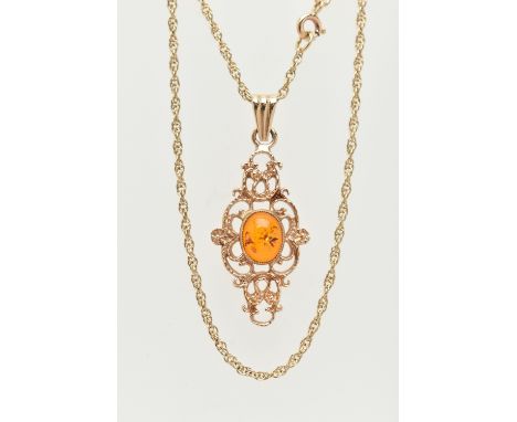 A 9CT GOLD PENDANT AND CHAIN, of an openwork scrolling design with a central oval imitation amber cabochon, suspended from a 