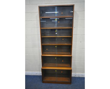 A 20TH CENTURY SIMPLEX SIX SECTION MAHOGANY STACKING BOOKCASE, all sections with double sliding glass doors, one section with