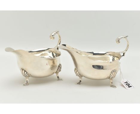 A PAIR OF GEORGE V SAUCE BOATS, typical form silver sauce boats, scalloped rim, scrolled handle with acanthus detail, raised 