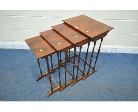 AN EARLY 20TH CENTURY FLAME MAHOGANY QUARTETTO NEST OF FOUR TABLES, raised on turned supports, shaped legs, united by stretch