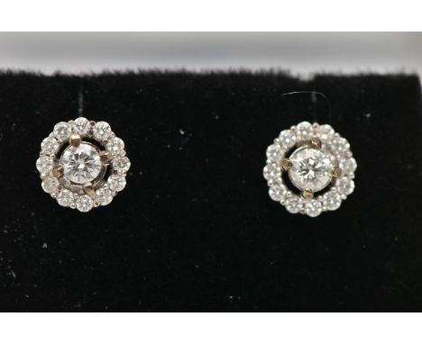 A PAIR OF 9CT WHITE GOLD DIAMOND CLUSTER STUD EARRINGS, centering on a round brilliant cut diamond, estimated diamond weight 