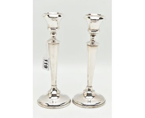 A PAIR OF EARLY 20TH CENTURY CANDLESTICKS, tapering stems, on round weighted bases, hallmarked 'A J Pepper &amp; Co' Birmingh