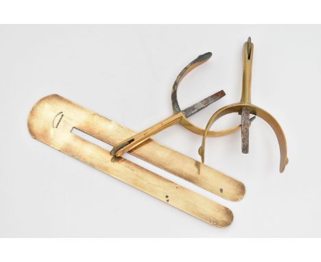 A PAIR OF BRASS SPURS AND A BUTTON CLEANER, all of simple design, approximate lengths 110 and 175mm