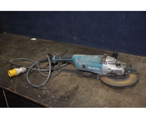 A MAKITA A9020 110V 9in ANGLE GRINDER with key (working but slow to start, spindle lock stiff)