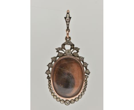 A YELLOW AND WHITE METAL PASTE SET DOUBLE LOCKET PENDANT, of an oval form one side with a photo of an eye, the other side wit