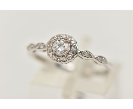 A 9CT WHITE GOLD DIAMOND RING, centering on a round brilliant cut diamond, estimated diamond weight 0.20ct, in a surround of 