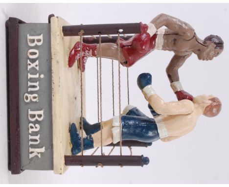 MONEY BOX; A 20th century cast iron automaton style money box / bank in the form of a boxing ring, with cast notation to side